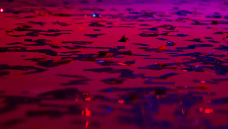 Close-Up-Of-Sparkling-Confetti-On-Floor-Of-Nightclub-Bar-Or-Disco-With-Flashing-Strobe-Lighting-2